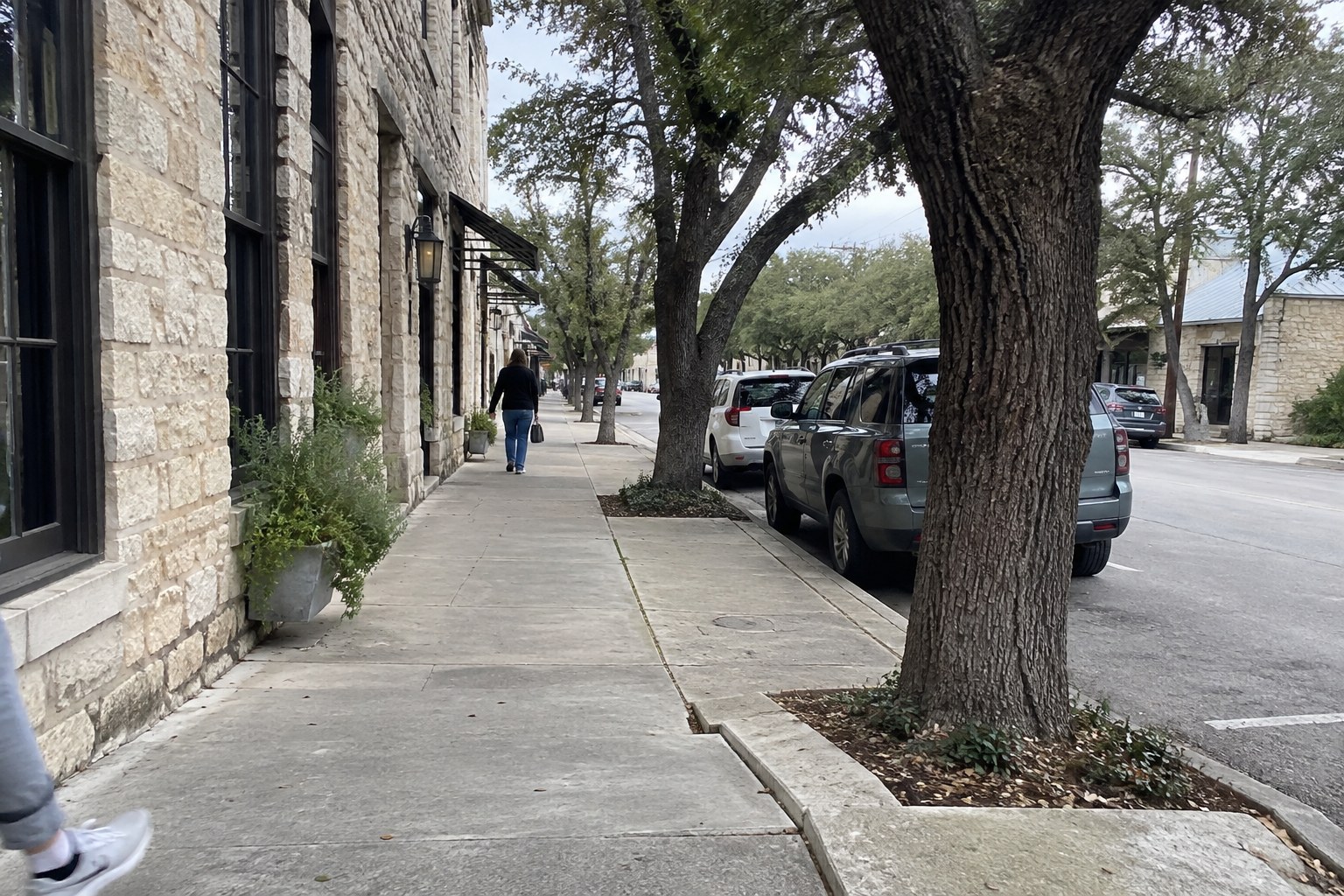 Sidewalk along historic limestone buildings in downtown Fredericksburg, TX