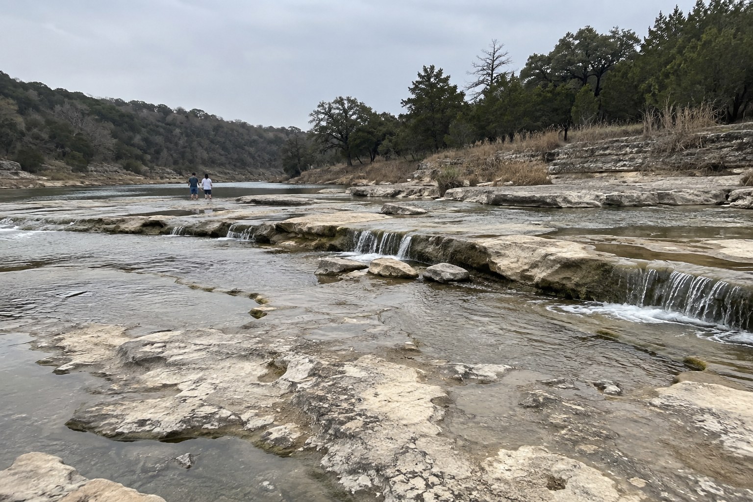 Shallow limestone falls at a Texas Hill Country swimming hole